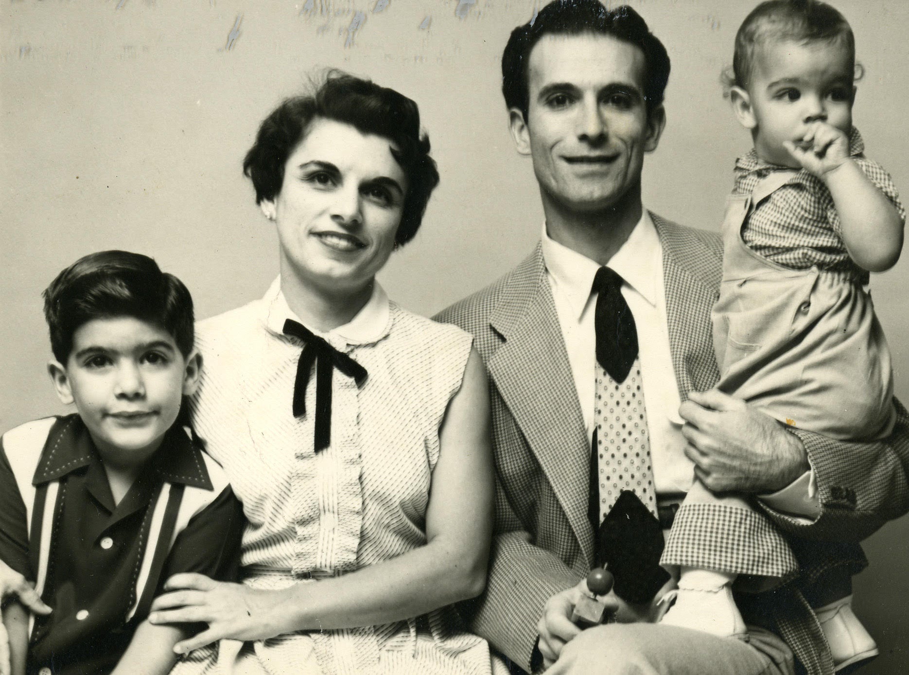 Black and white Gonzmart family portrait of a couple with two children.