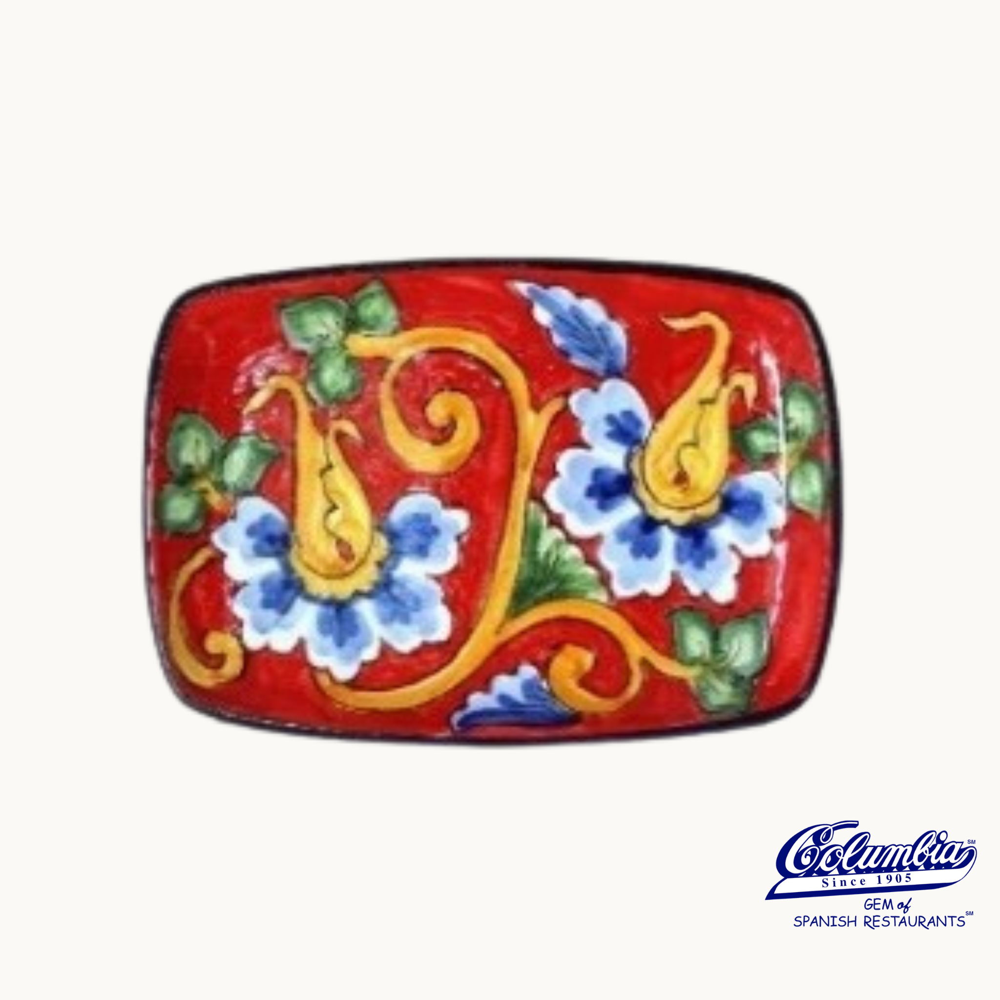 Decorative red plate with blue and yellow floral patterns on a white background.