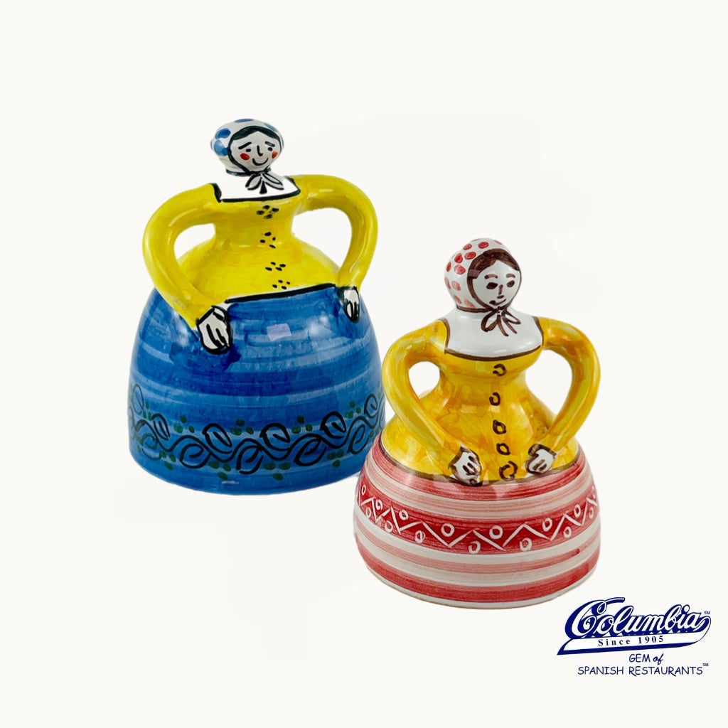 Two colorful ceramic figurines with decorative patterns on a white background, featuring the Columba brand.
