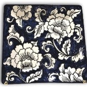 A square ceramic plate with a blue and white floral gardenia pattern.