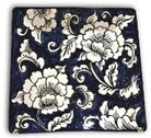 A square ceramic plate with a blue and white floral gardenia pattern.