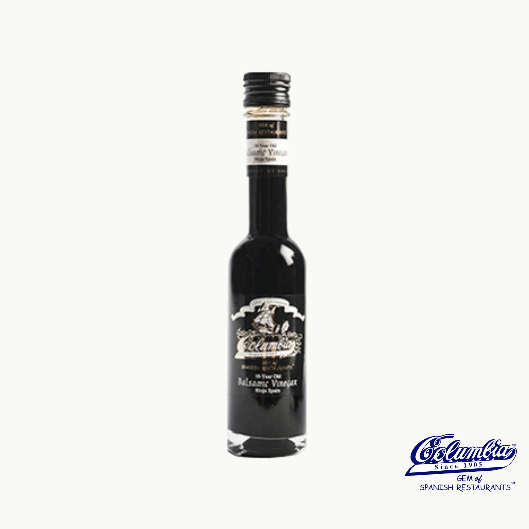 A bottle of Columbia 10-year-old Balsamic Vinegar from Rioja, Spain, with a black label and a decorative logo in white.