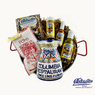 A gift set including a traditional Spanish paella pan, a hand-painted Spanish ceramic pitcher, various condiments and a cooking book.