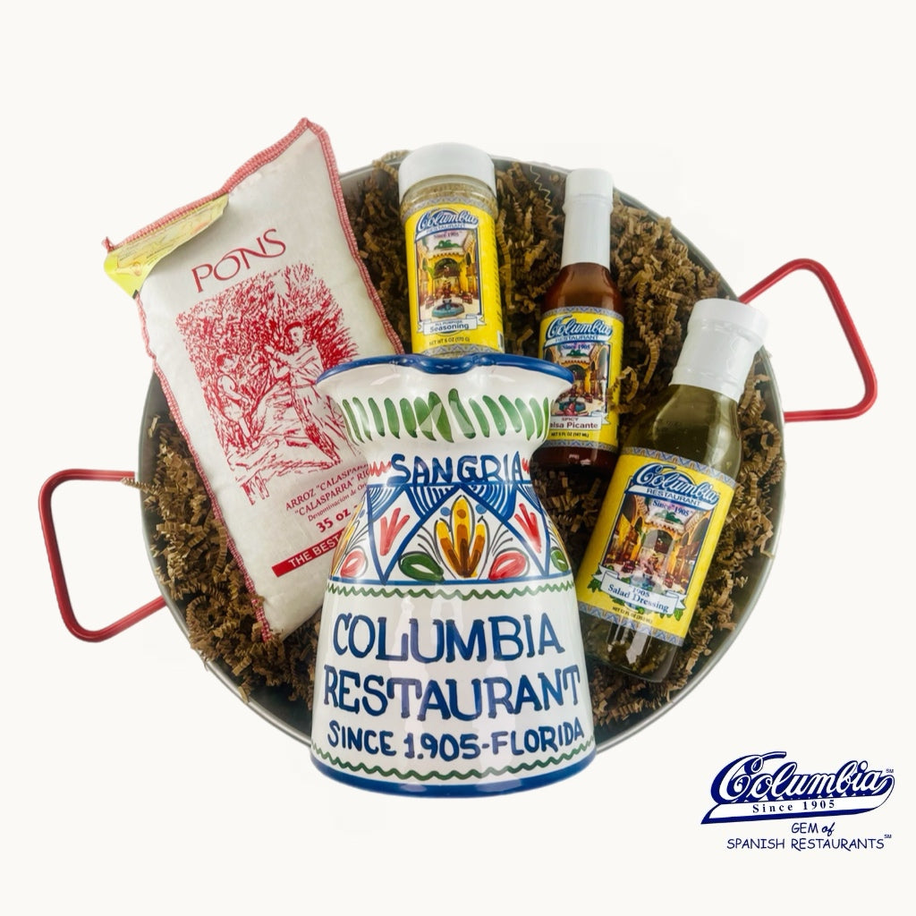 Decorative items including a ceramic container, bottles, and a bag with 'Columbia Restaurant' branding.