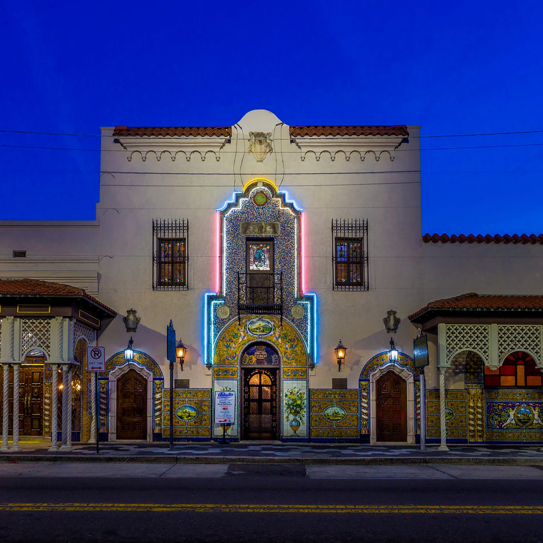 Decorative building facade with intricate designs and lighting at night