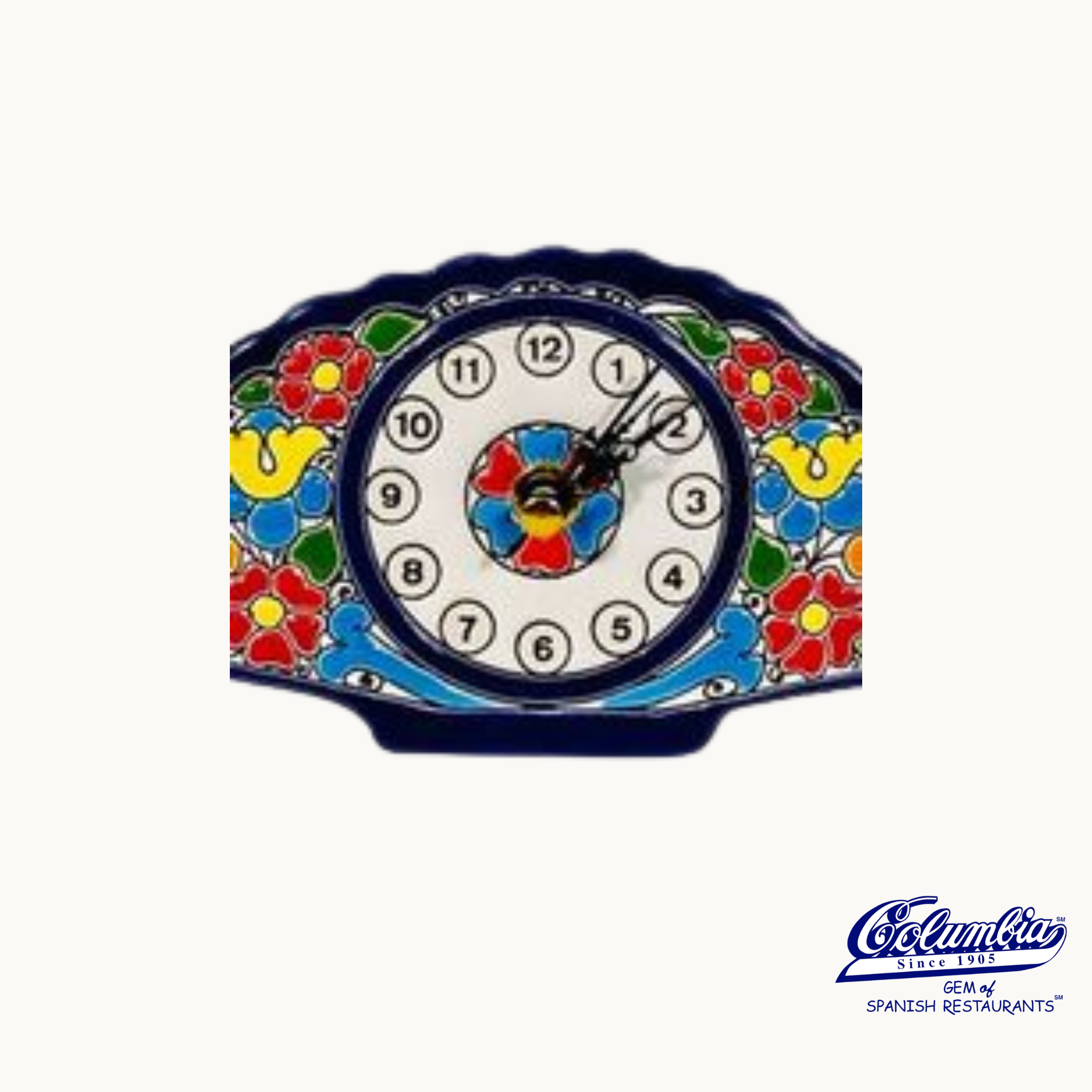 A fan-shaped wall clock with a colorful floral pattern around the edge and a white clock face with black numbers.
