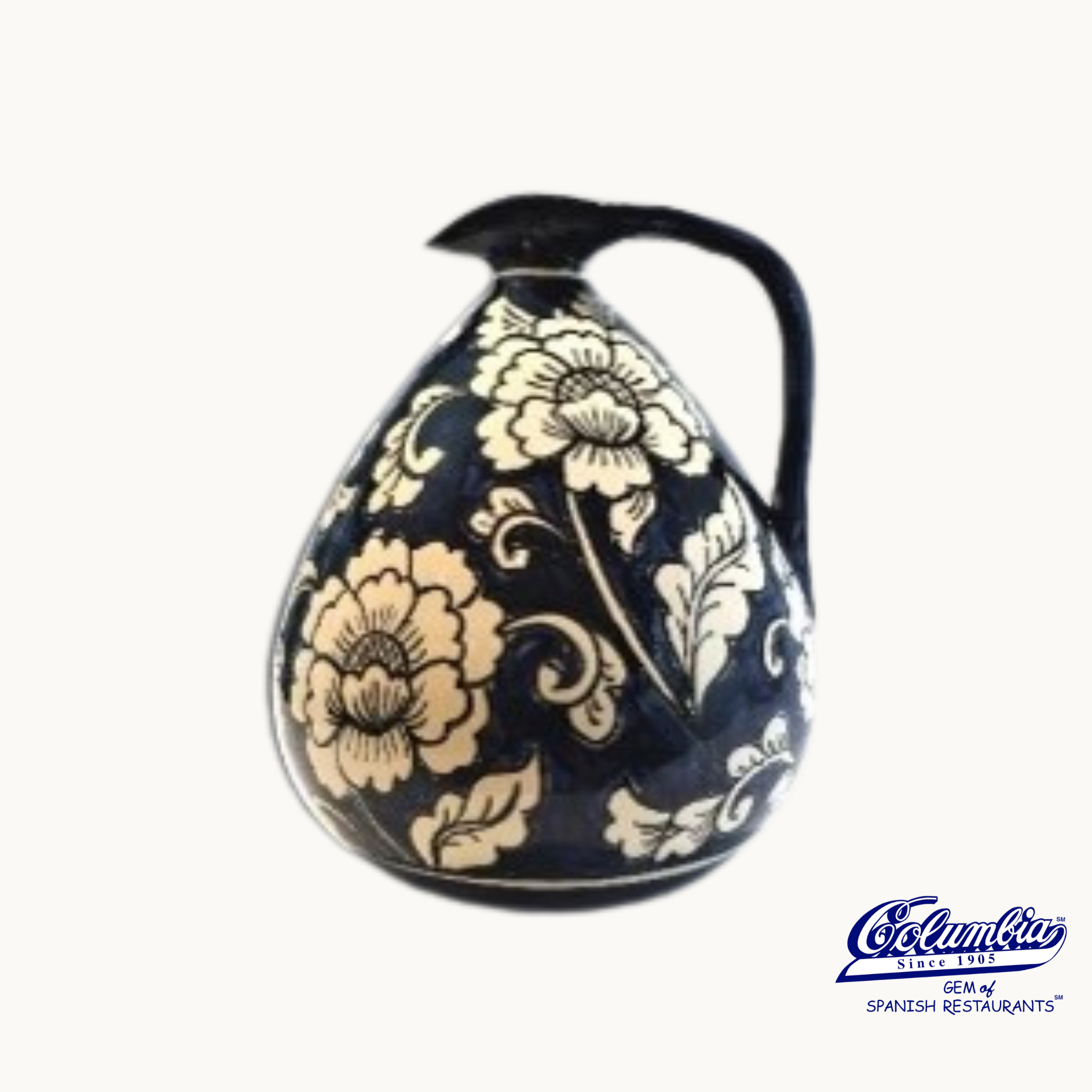Decorative ceramic pitcher with floral patterns on a white background