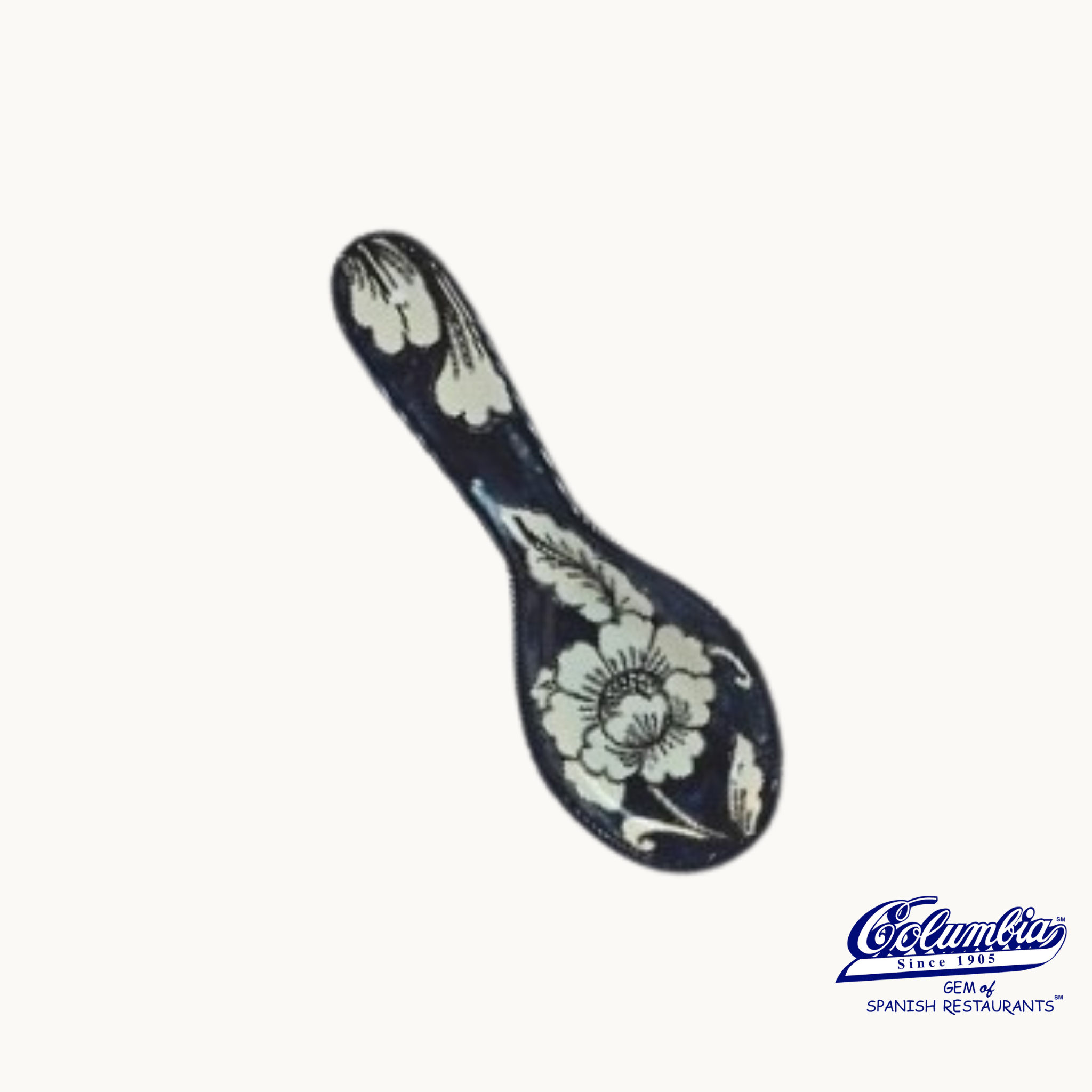 Spoon-shaped decorative item with floral patterns on a white background