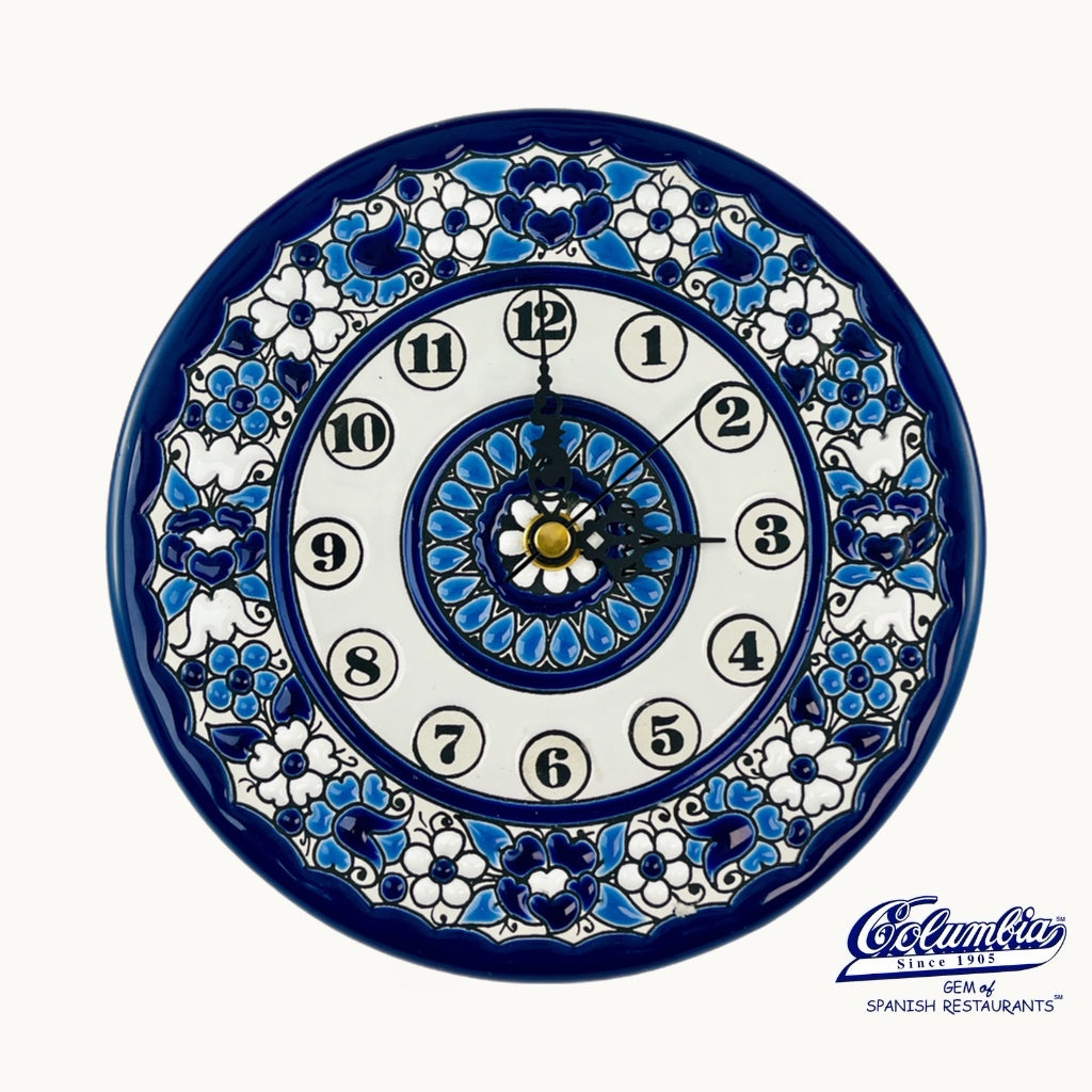 Decorative wall clock with blue and white floral patterns on a white background