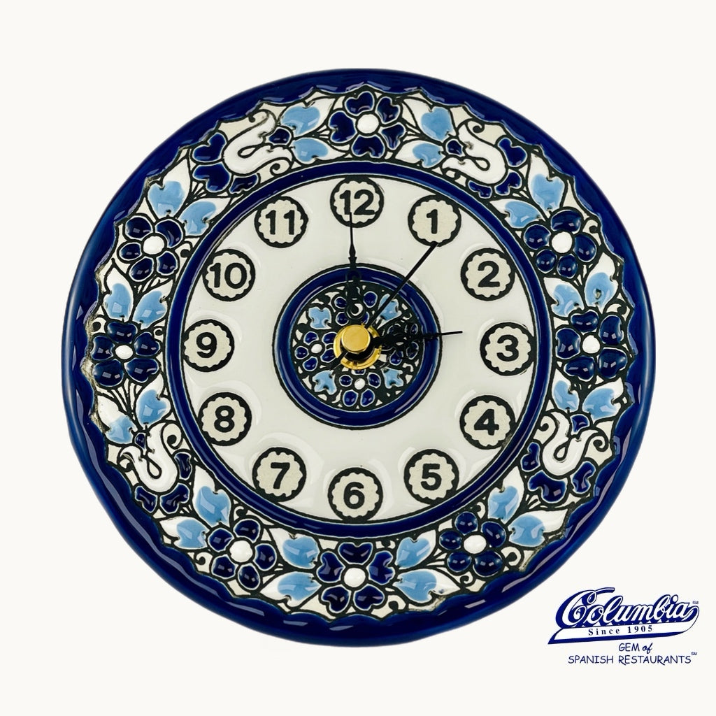 Decorative wall clock with blue and white floral patterns on a white background