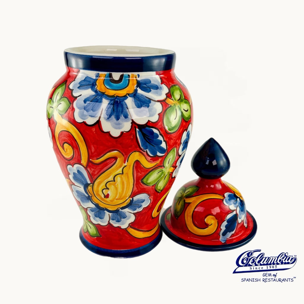 Colorful ceramic vase with floral patterns on a white background, featuring the Cofano logo.