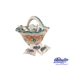 Decorative ceramic basket with colorful floral patterns holding Columbia brand packets on a white background.
