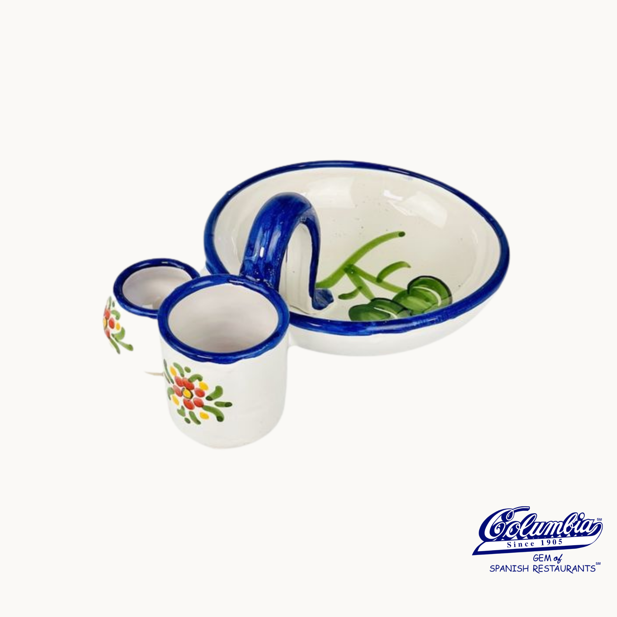 A hand-painted ceramic olive tray with blue patterns and a small cup, also with blue accents and floral motifs.