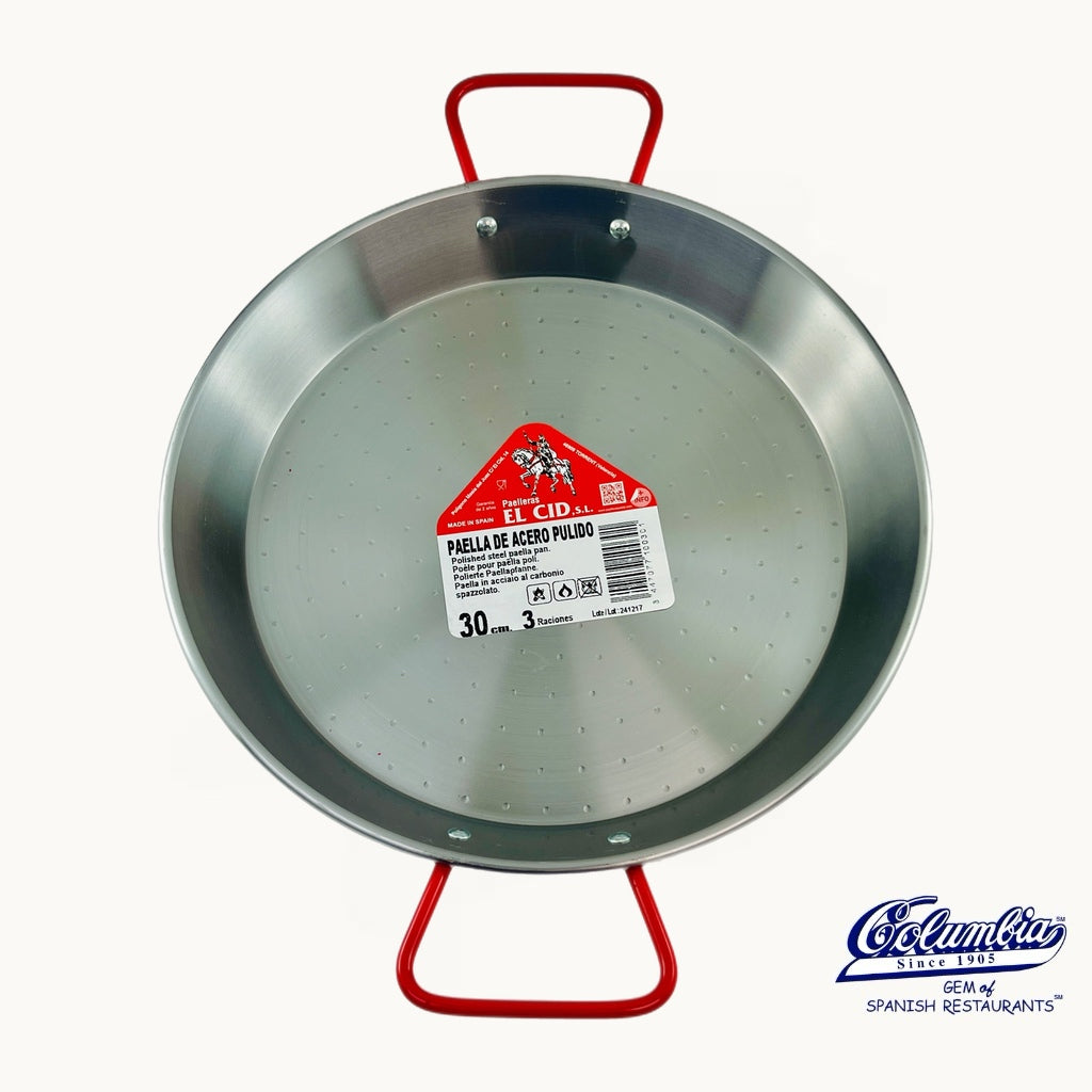 Metal paella pan with red handle and label on a white background