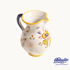 Ceramic pitcher with floral patterns on a white background