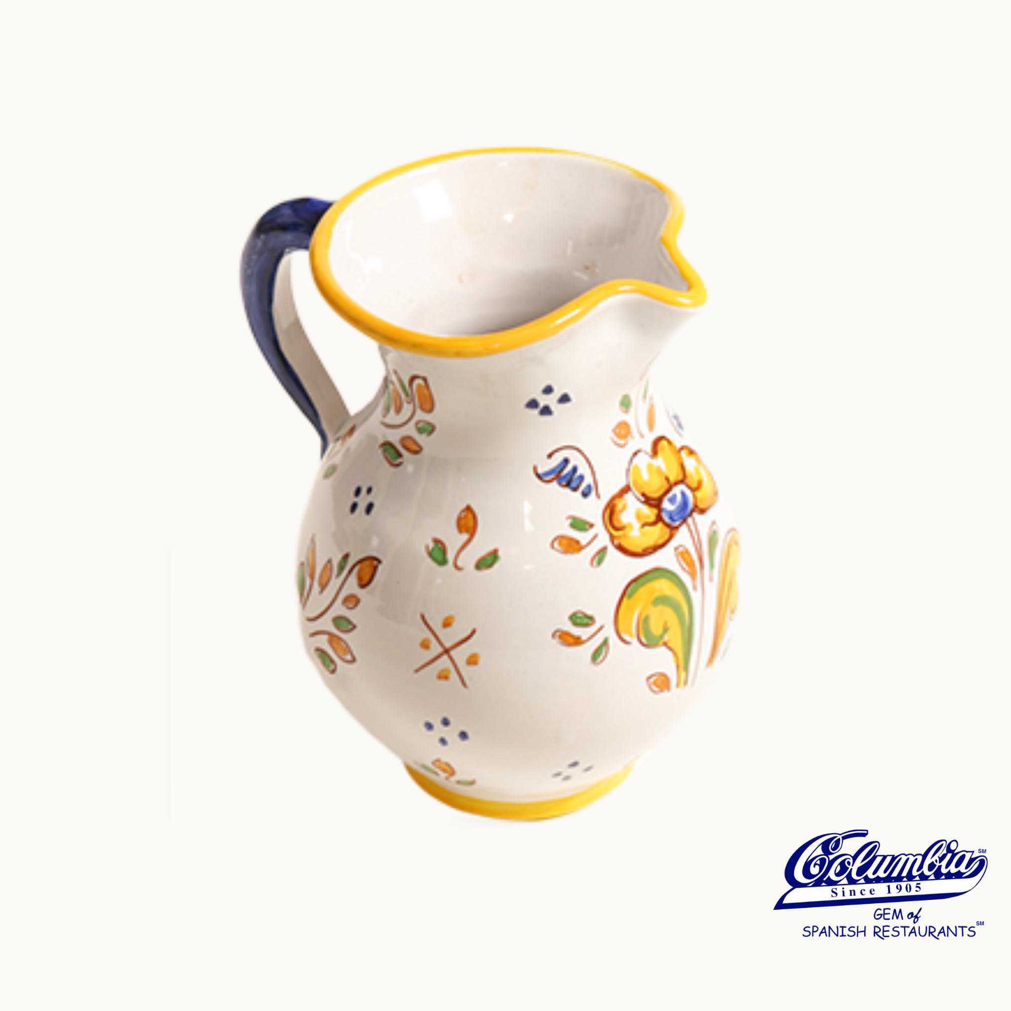 Ceramic pitcher with floral patterns on a white background