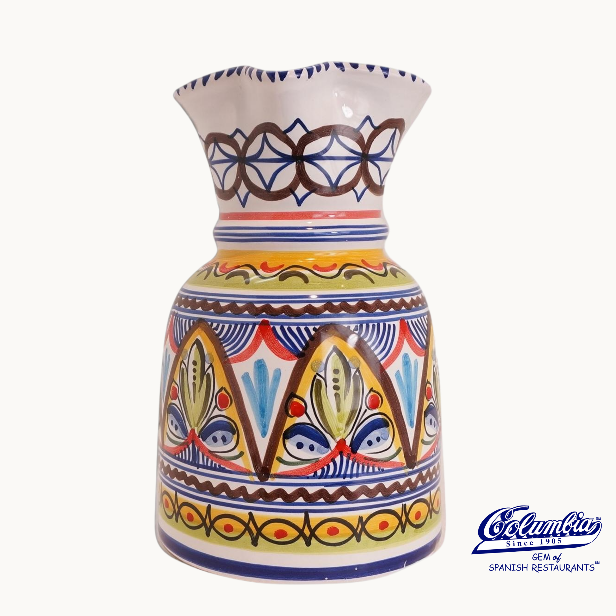 Colorful ceramic pitcher with intricate patterns on a white background