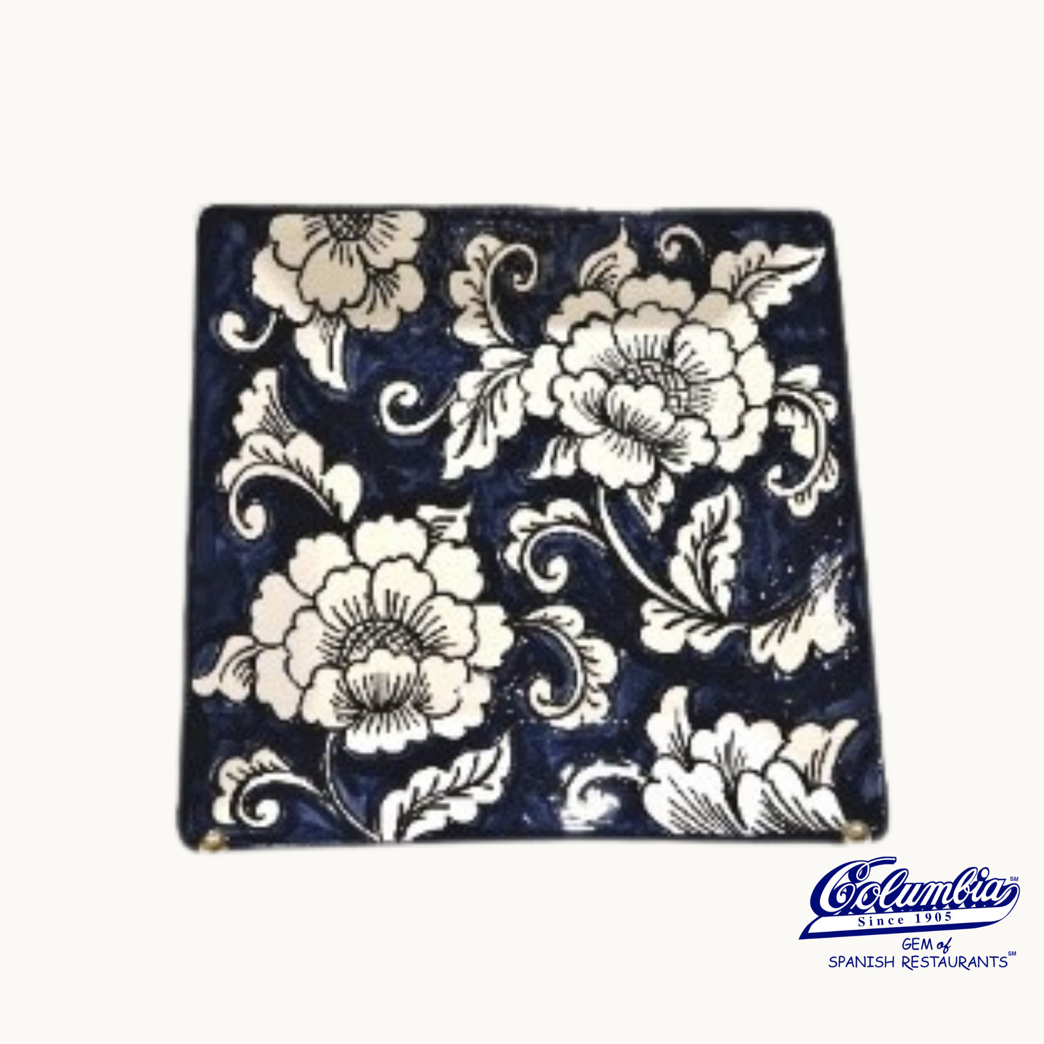 A square ceramic plate with a blue and white floral gardenia pattern.