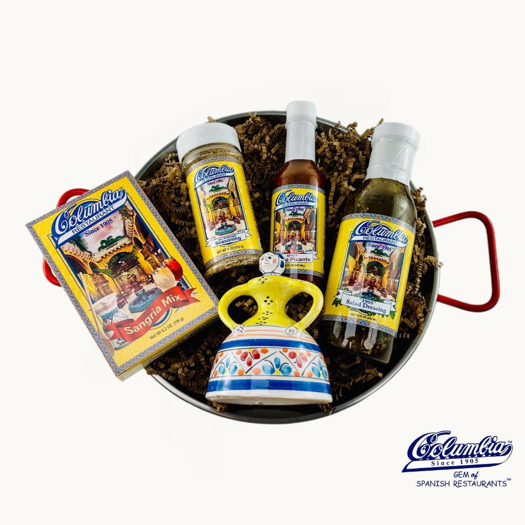 Culinary gift set with bottles, a box, and a decorative mug on a white background.