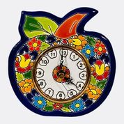 Hand-painted ceramic wall clock in the shape of an apple, decorated with vibrant floral and leaf patterns in red, yellow, green, and blue, with a round clock face in the center.