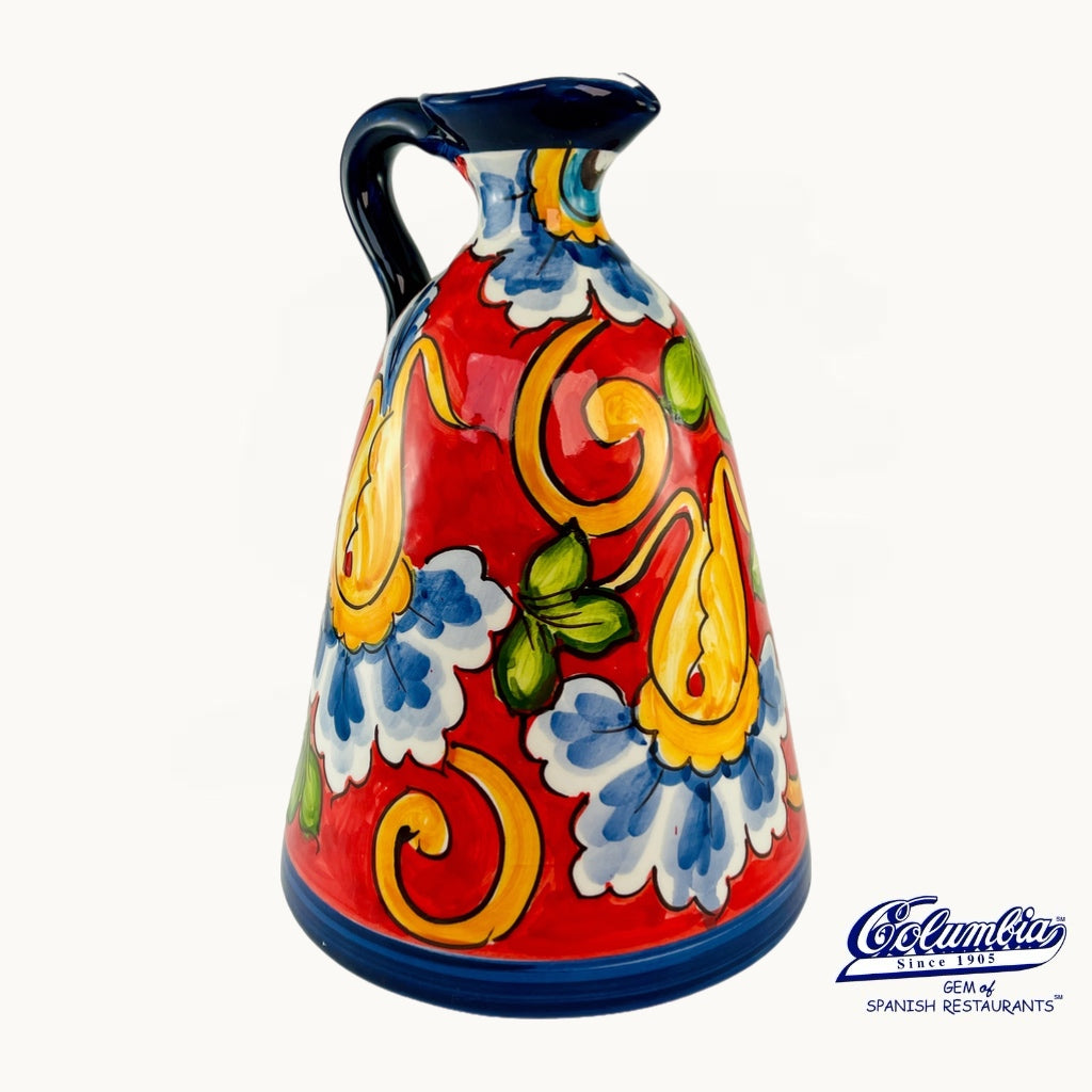 Decorative ceramic pitcher with colorful floral patterns on a white background