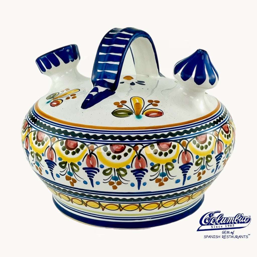 A white jar with floral designs and a blue handle on top