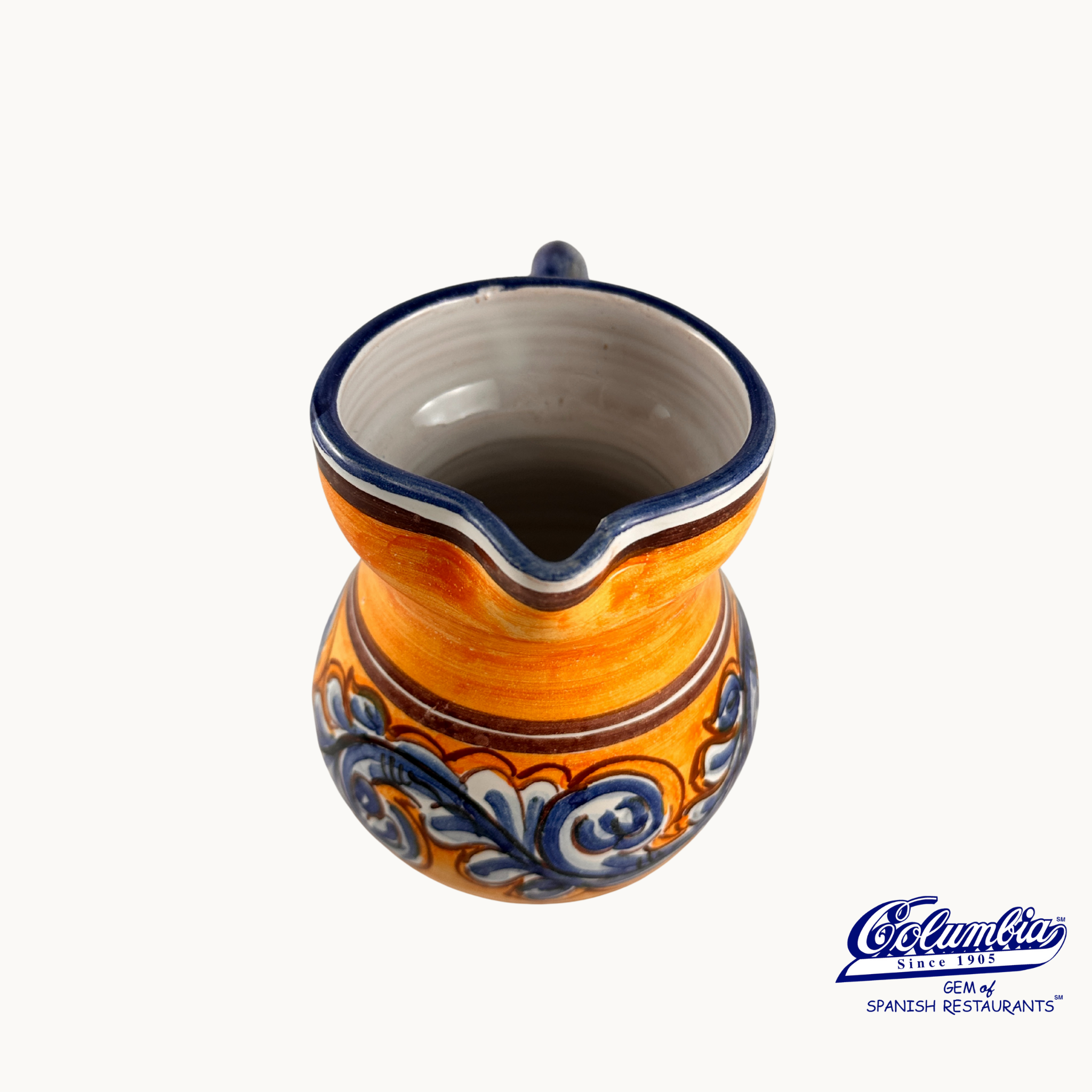 Ceramic pitcher with blue and white patterns on a white background
