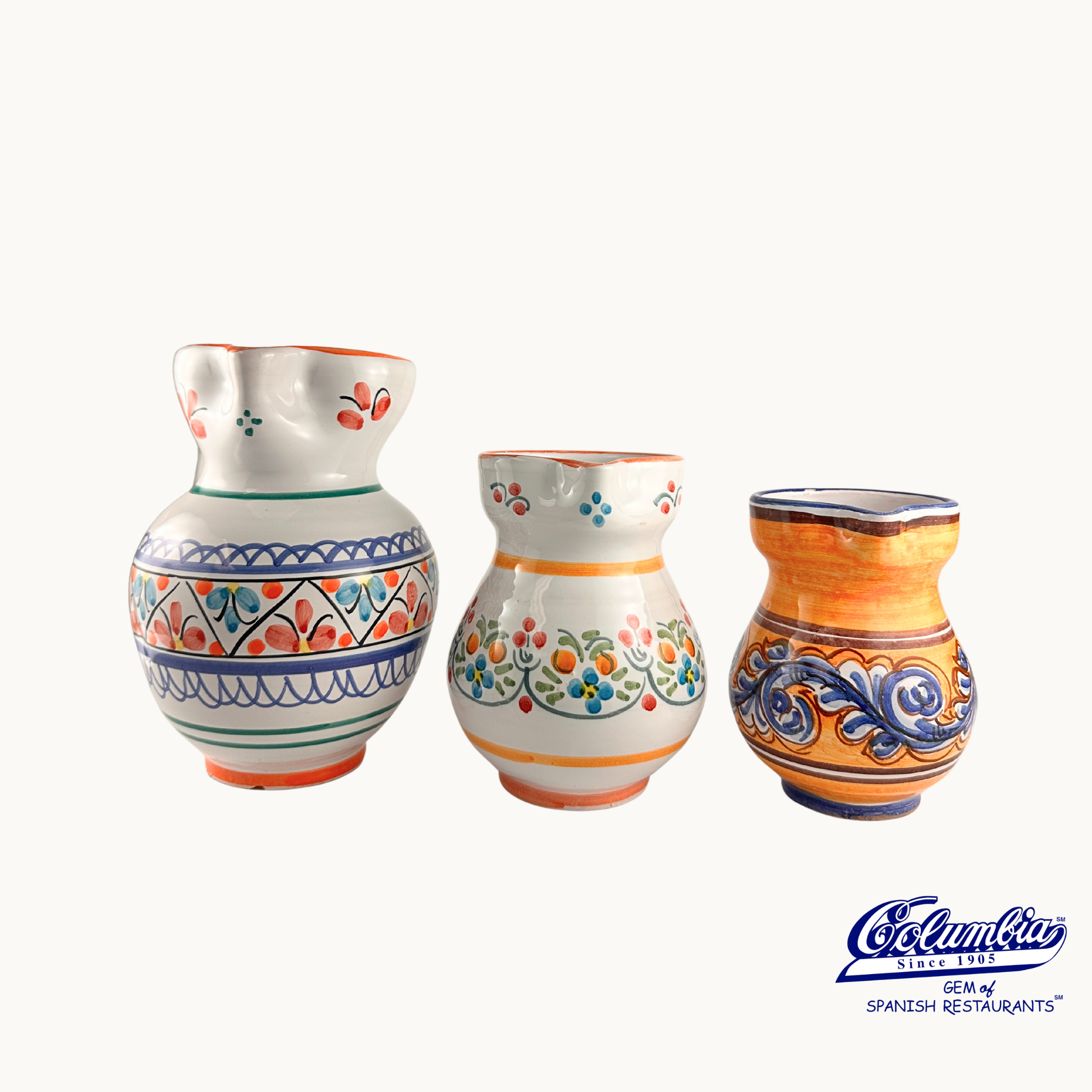 Three ceramic vases with colorful patterns on a white background, featuring the 'Columba' brand.