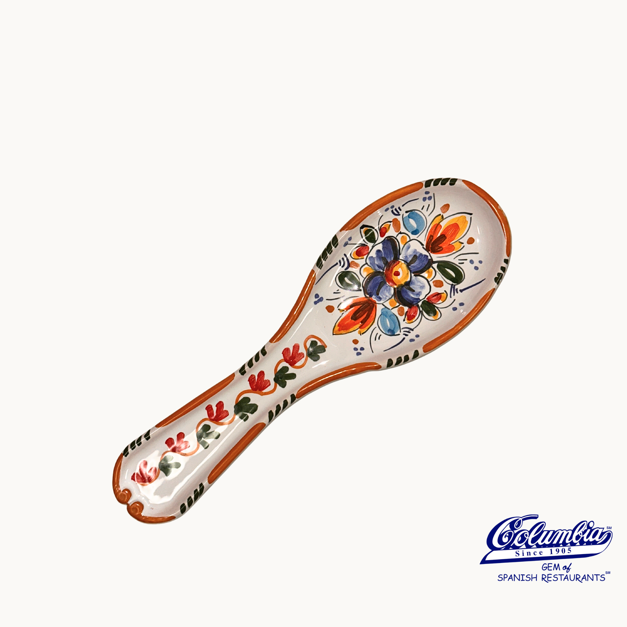 Ceramic spoon rest with colorful floral patterns on a white background top view