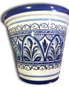 A small, hand-painted flower pot with blue and white floral patterns.