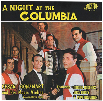 Album cover of 'A Night at the Columbia' featuring Cesar Gonzmart and his Magic Violins. The image includes several people, likely the band, in a indoor setting with a staircase in the background.