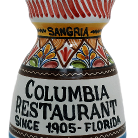 A ceramic pitcher with hand-painted patterns, predominantly white with a colorful geometric design, and text that reads 'COLUMBIA RESTAURANT SINCE 1905 - FLORIDA'.