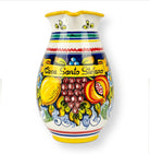 A medium-sized, hand-painted ceramic pitcher with colorful Sicilian-inspired restaurant branding 'Casa Santo Stefano' and fruit motifs.