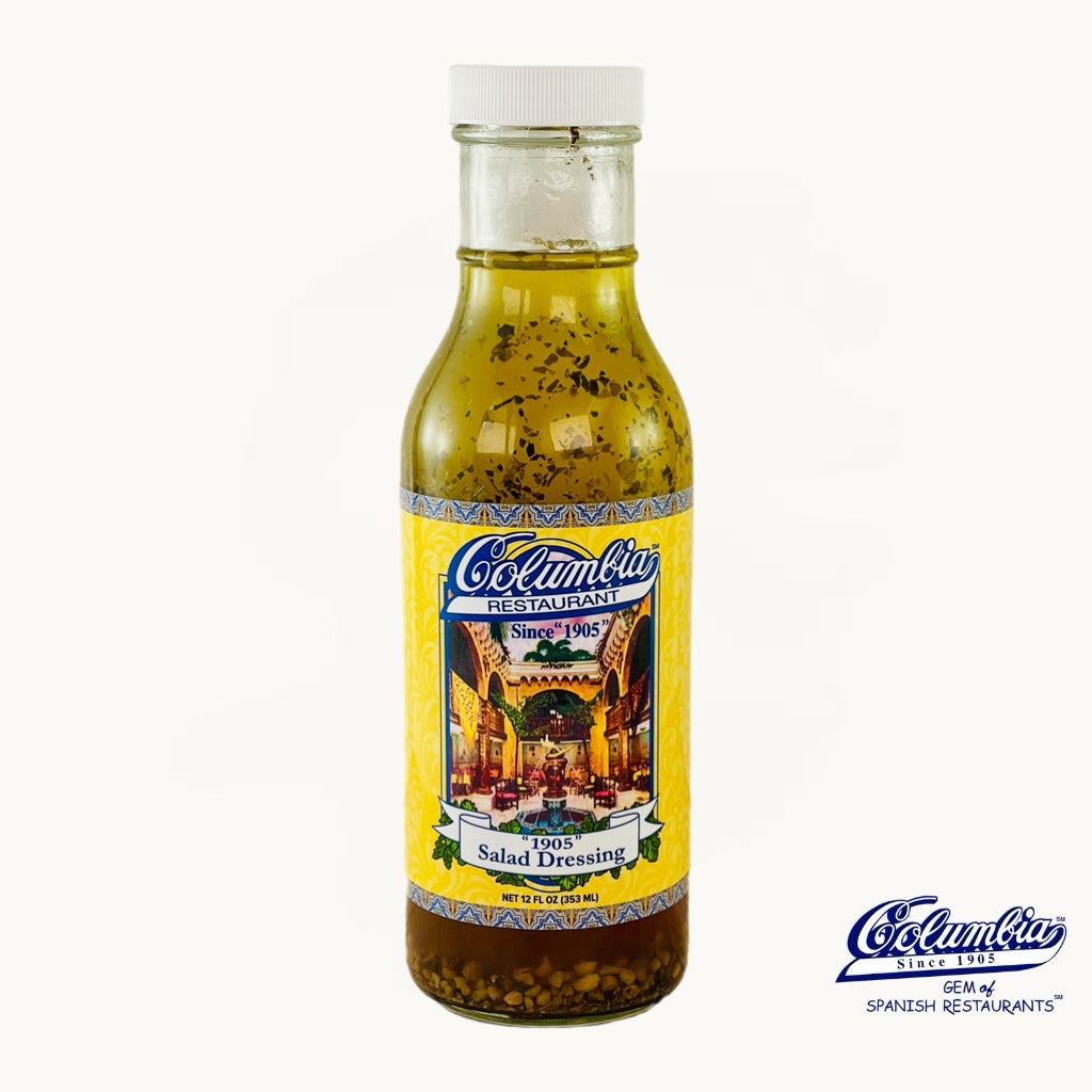 Bottle of Columba salad dressing with a yellow label on a white background