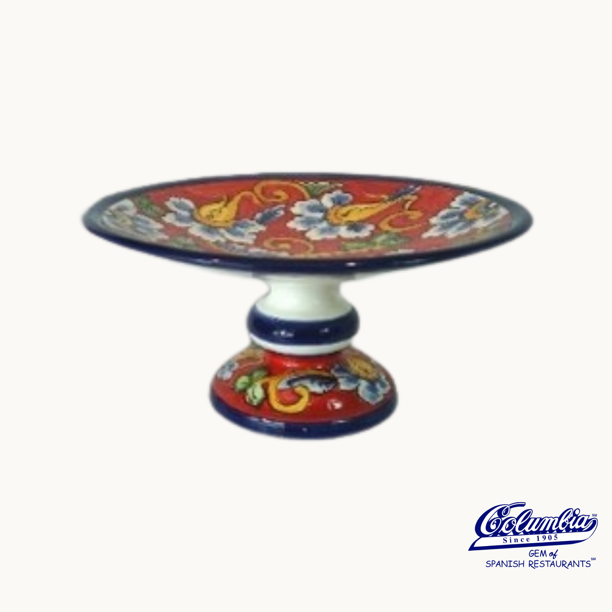 Colorful ceramic cake or fruit stand with floral designs on a white background