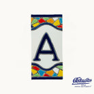 Decorative tile with letter 'A' and colorful border on a white background