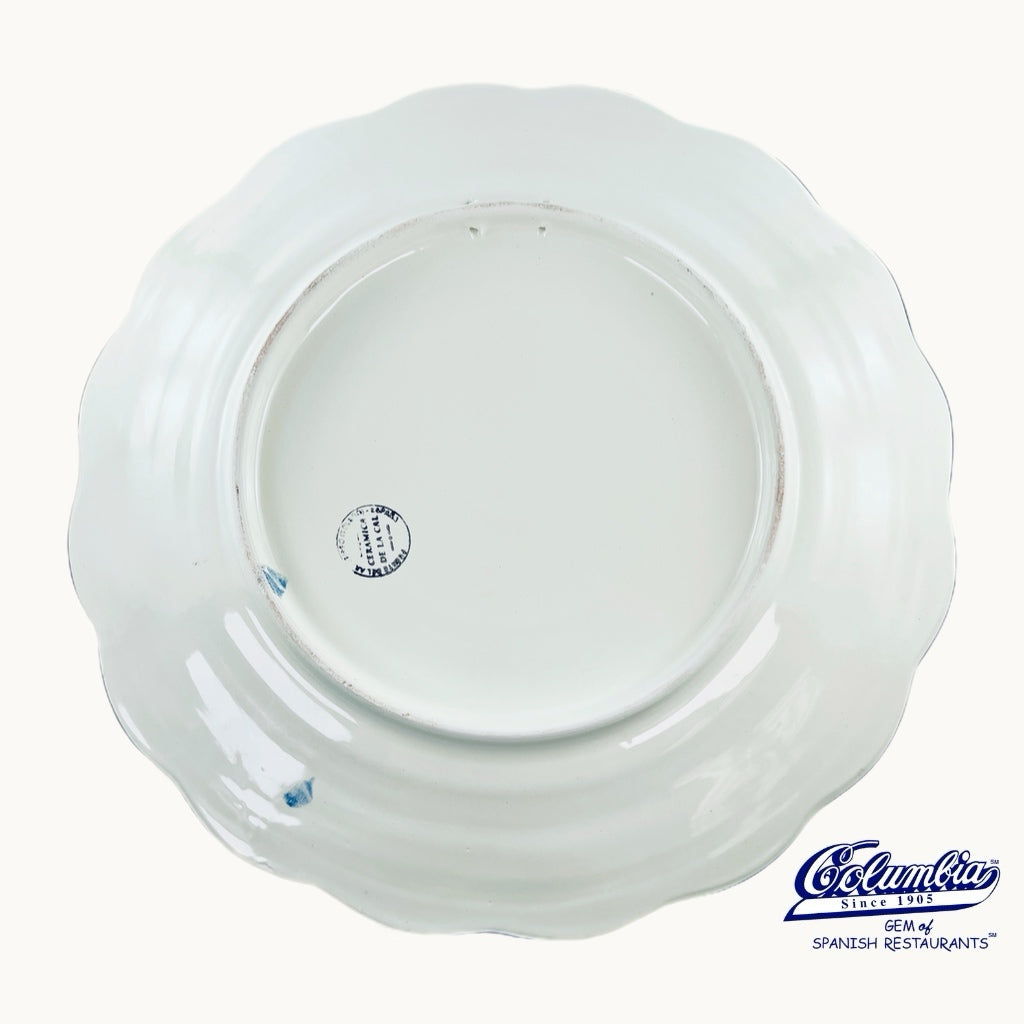 Back of ceramic plate with a logo on it.