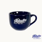 A blue ceramic cappuccino mug with the Columbia Restaurant logo printed on it.