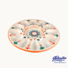 Decorative ceramic plate with floral patterns on a white background, featuring the Cocinilla logo.