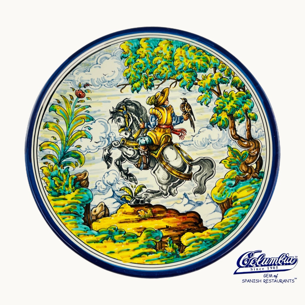 Decorative plate with a man on a horse and a bird held by the man 