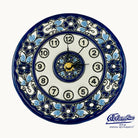 Decorative wall clock with blue and white floral patterns on a white background