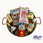Gift basket with various items including bottles and a bottle opener, featuring the Caudillo brand.