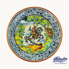 A decorative plate that has a man riding a horse holding a bird