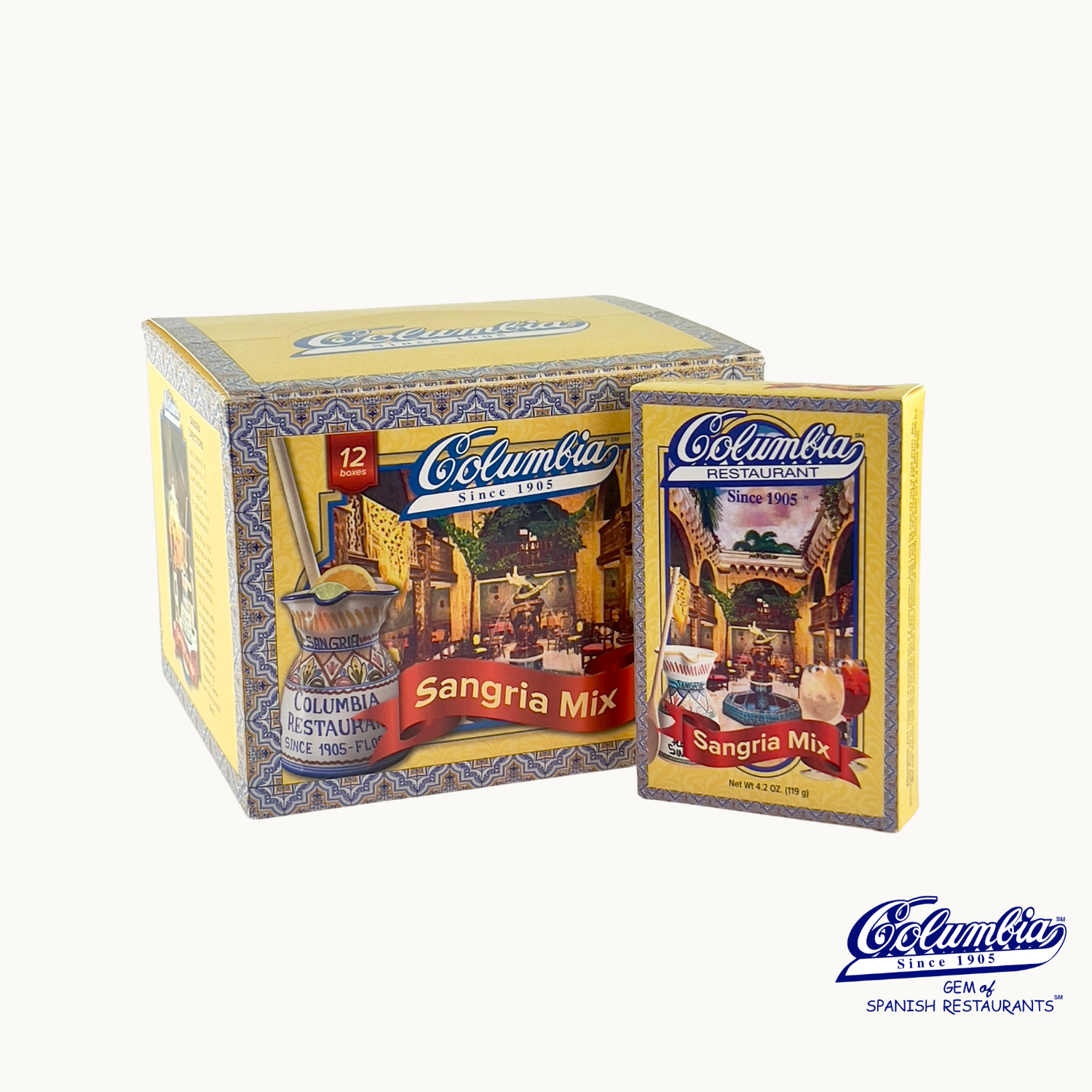 The image shows a 12 pack case of Columbia Sangria Mix, with individual sachets of the mix visible in front of the box. The packaging is predominantly in colors blue and yellow, with Spanish flag-like elements and traditional imagery.