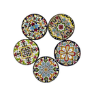 A set of five ceramic coasters with colorful floral patterns on a white background.