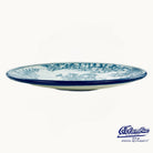Blue and white ceramic plate with floral patterns on a white background, featuring the Columba logo.