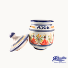 Decorative ceramic jar with colorful floral patterns and 'AJOS' text on a white background, featuring the Colmenar logo.