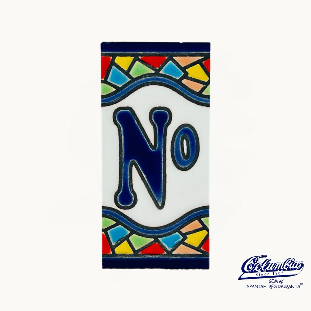 Decorative tile with the number '0' and colorful border on a white background