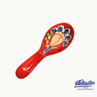 Decorative ceramic spoon rest with floral design on a white background, featuring the El Flamenco logo.