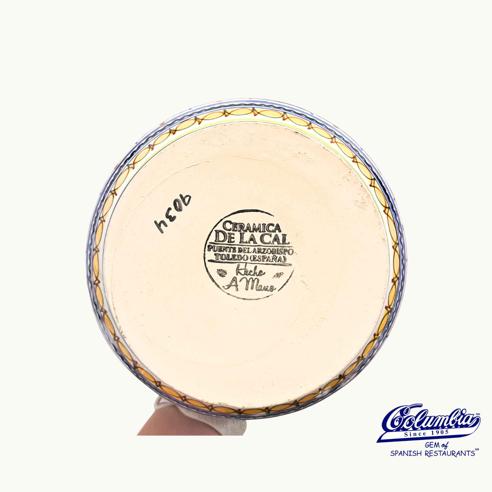 Ceramic plate with 'Ceramica de la Cal' branding on a white background